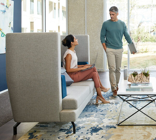 two individuals in a lobby seating area