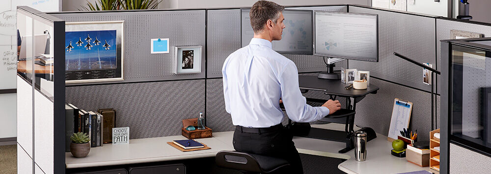 varidesk sit stand converter in a government office cubicle setting