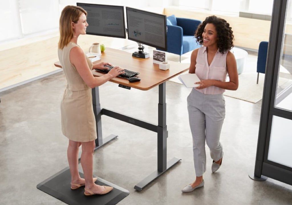 two professionals greet each other while standing