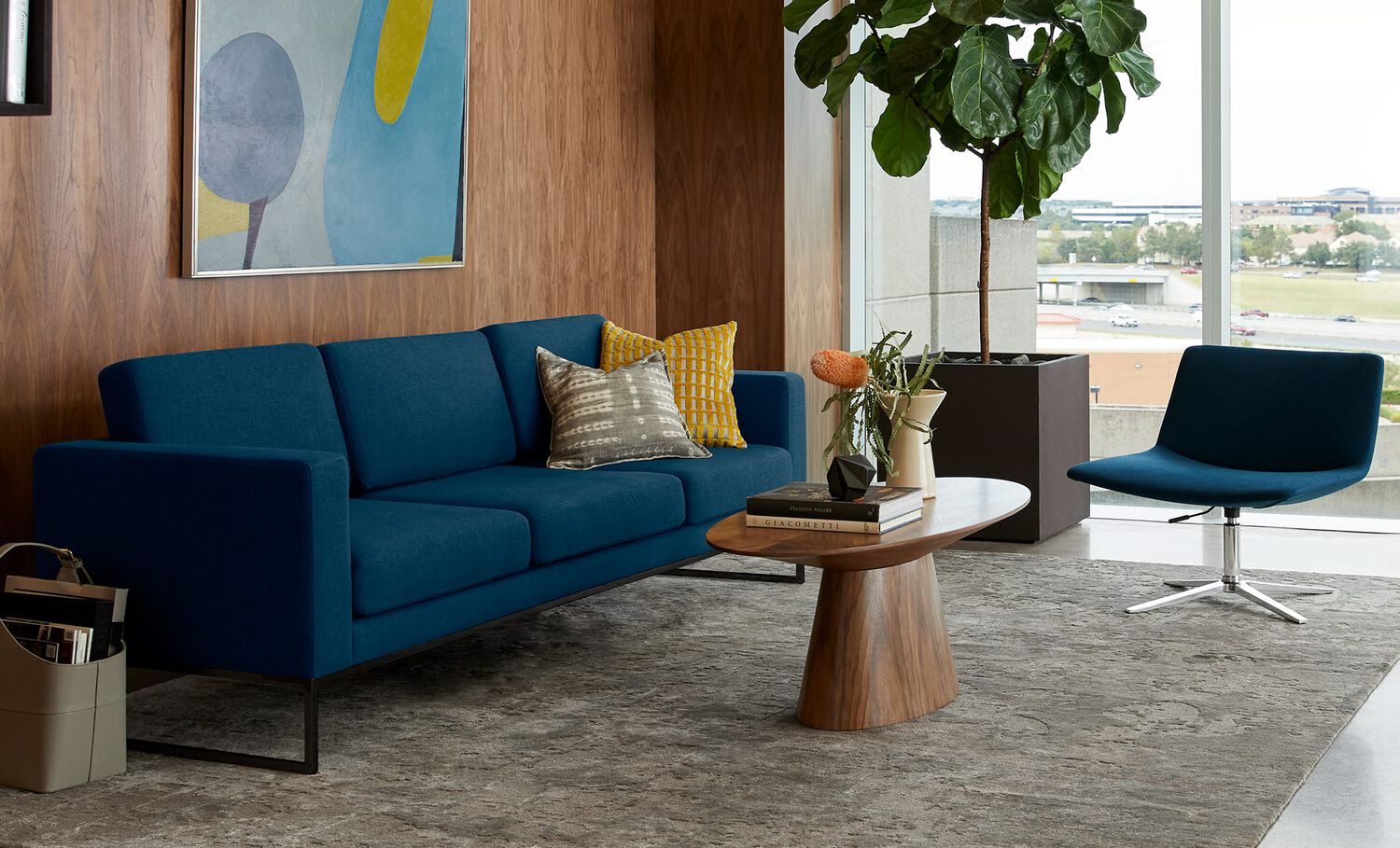 navy three seat sofa in office setting