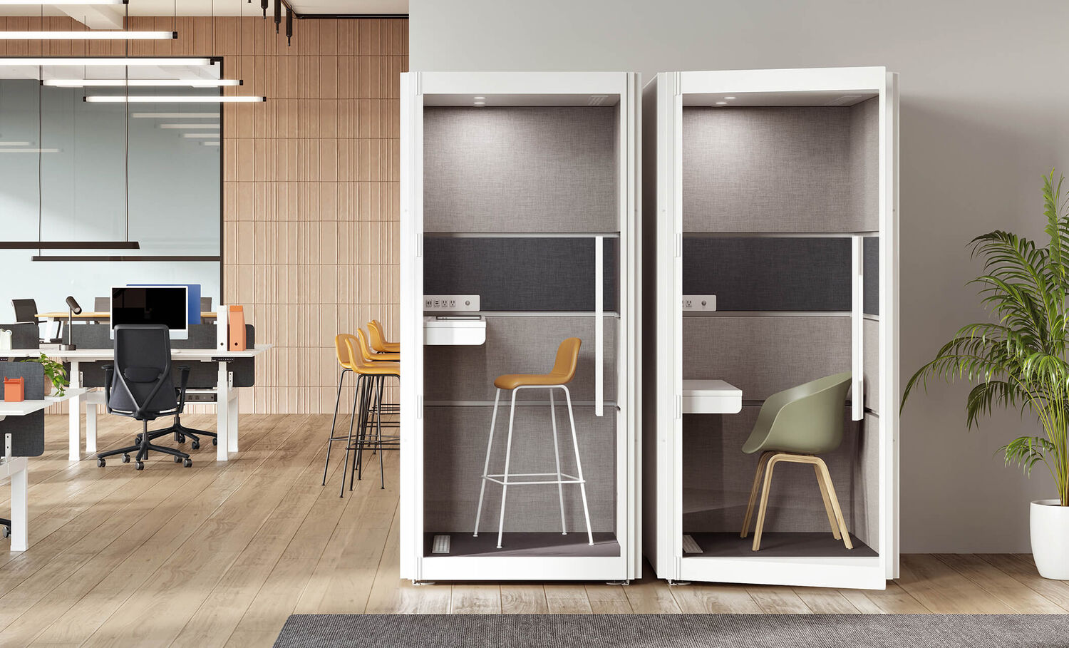 two one person privacy booths side by side in an open office against a wall