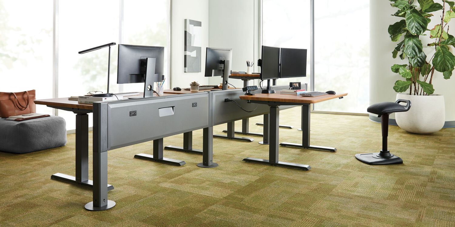 a few desk pushed together to create a desk pod