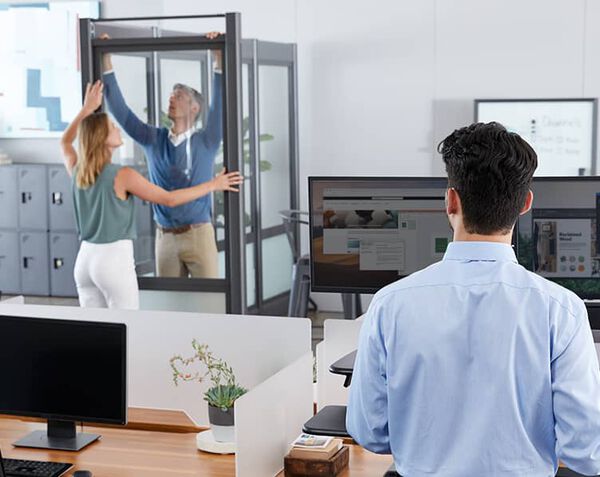 2 professionals installing quickflex walls in occupied working space