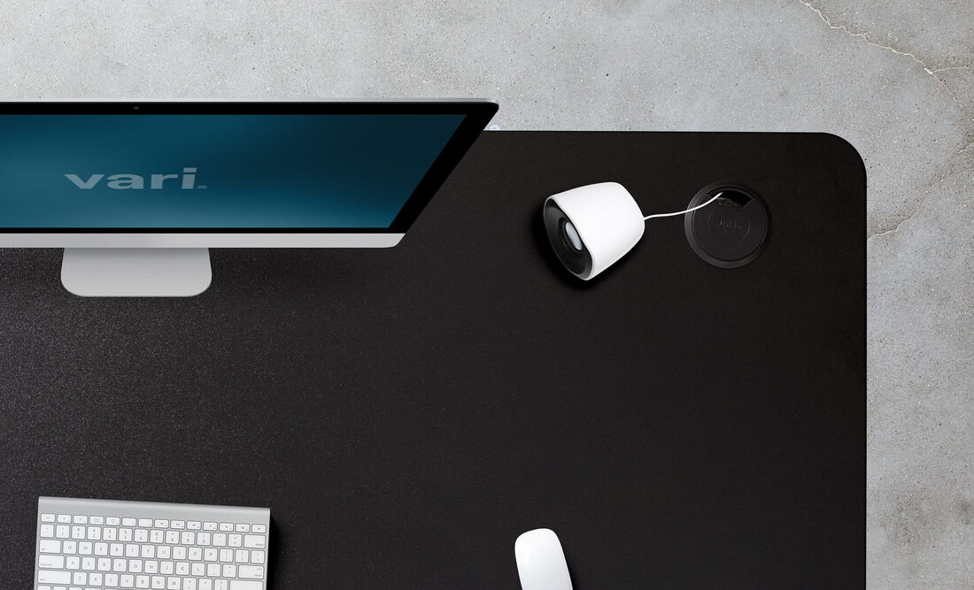 close up view of curve electric standing desk cable passthroughs and grommets