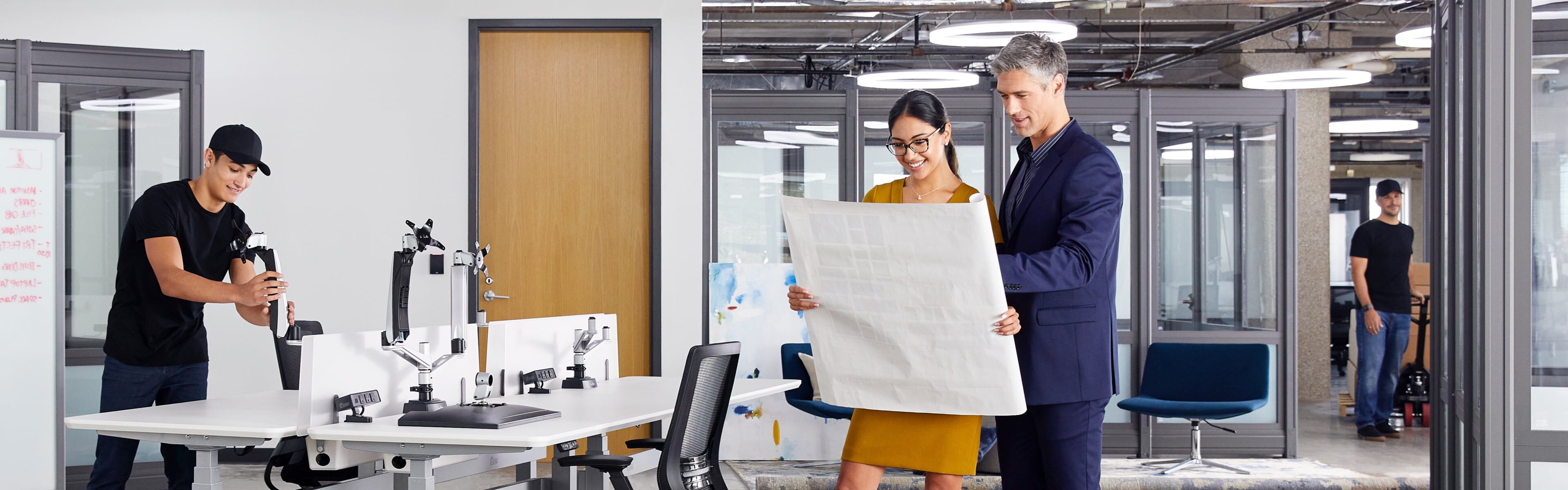 people reviewing a space plan in an office undergoing a furniture design project