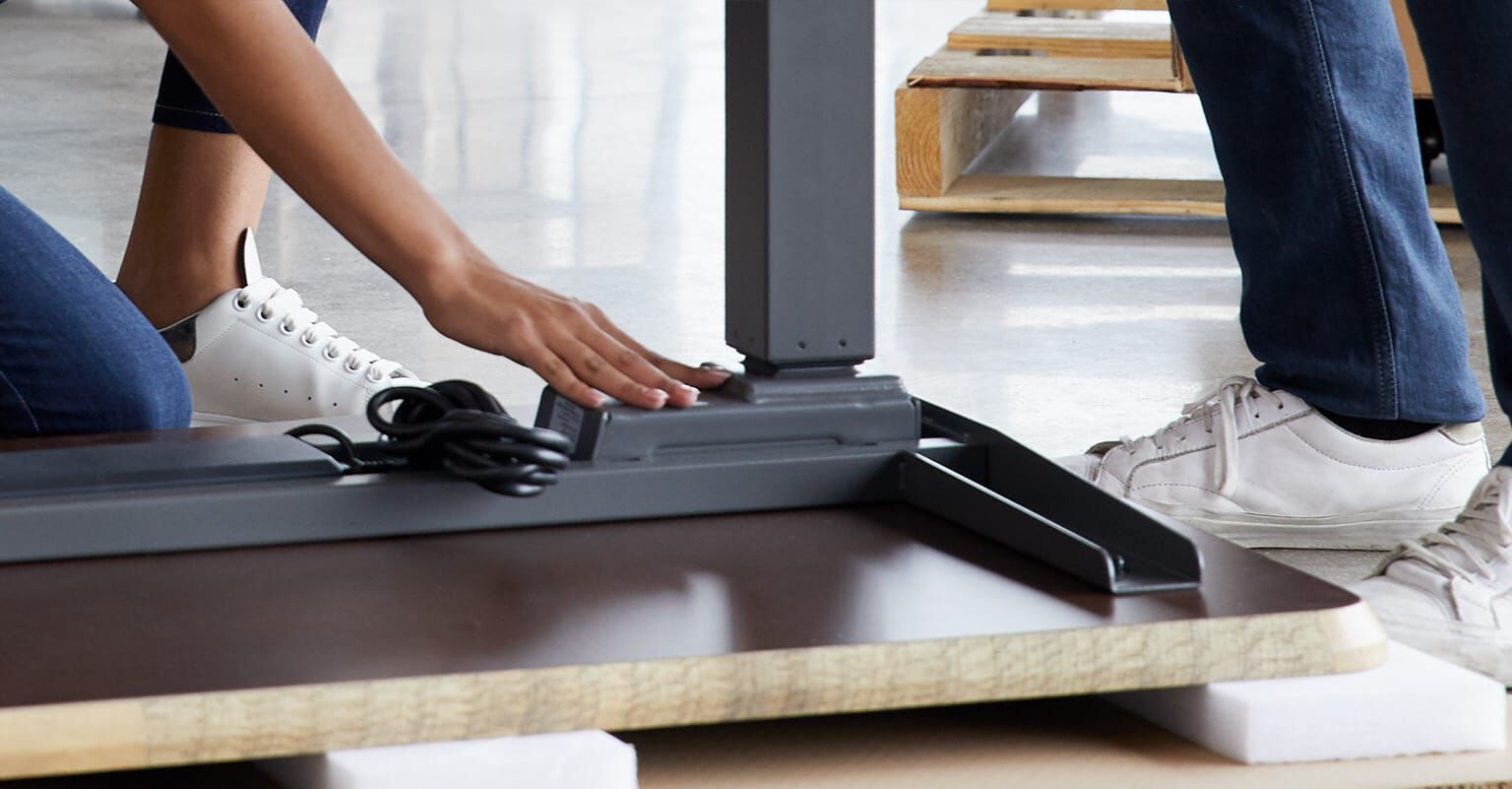vari electric standing desk being assembled