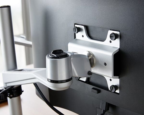 monitor bracket seen from back, bolted into montior with hand-turned screws