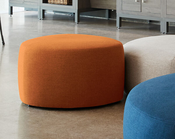 small ottoman with laptop and notebook on top