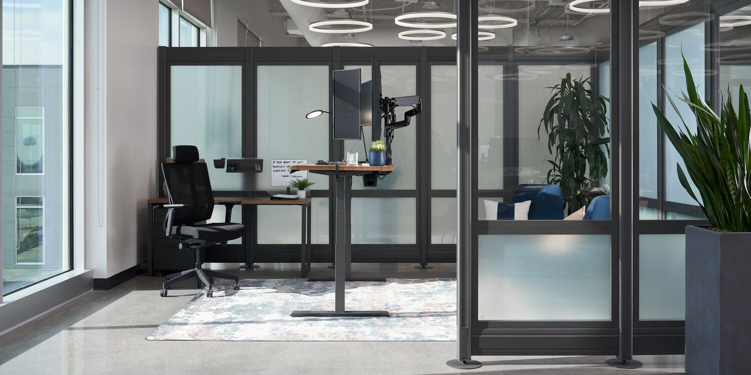 private office with standing desk and office chair