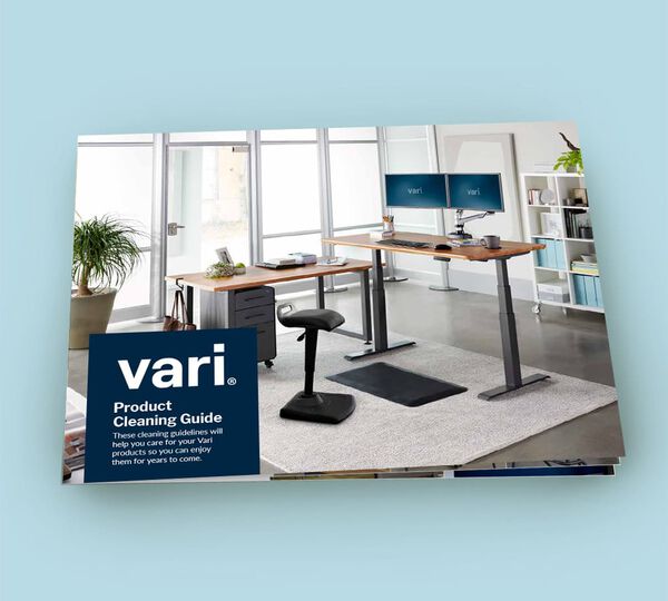 cover of product cleaning guide featuring an electric standing desk in an office