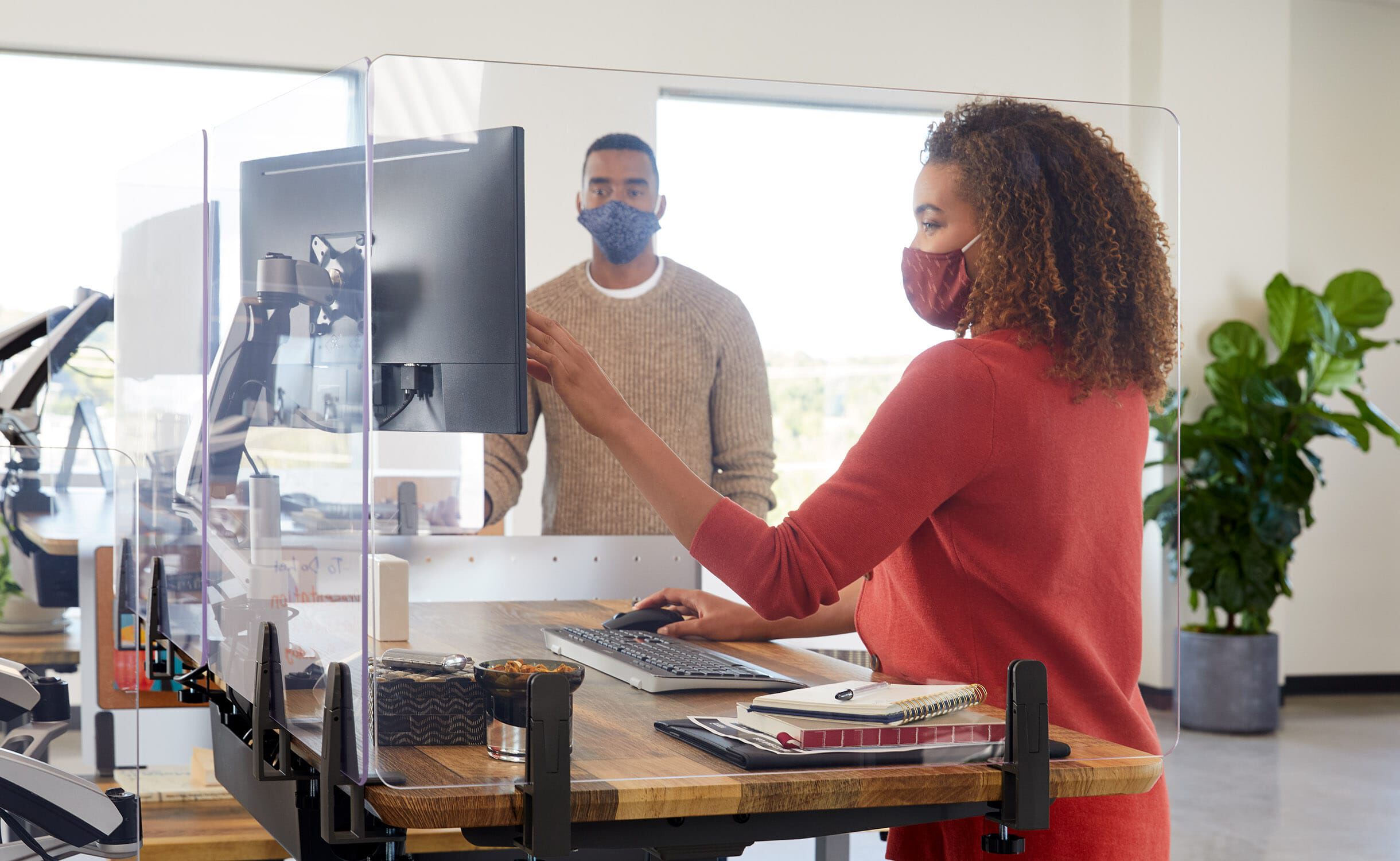 Professionals working in office space with vari products