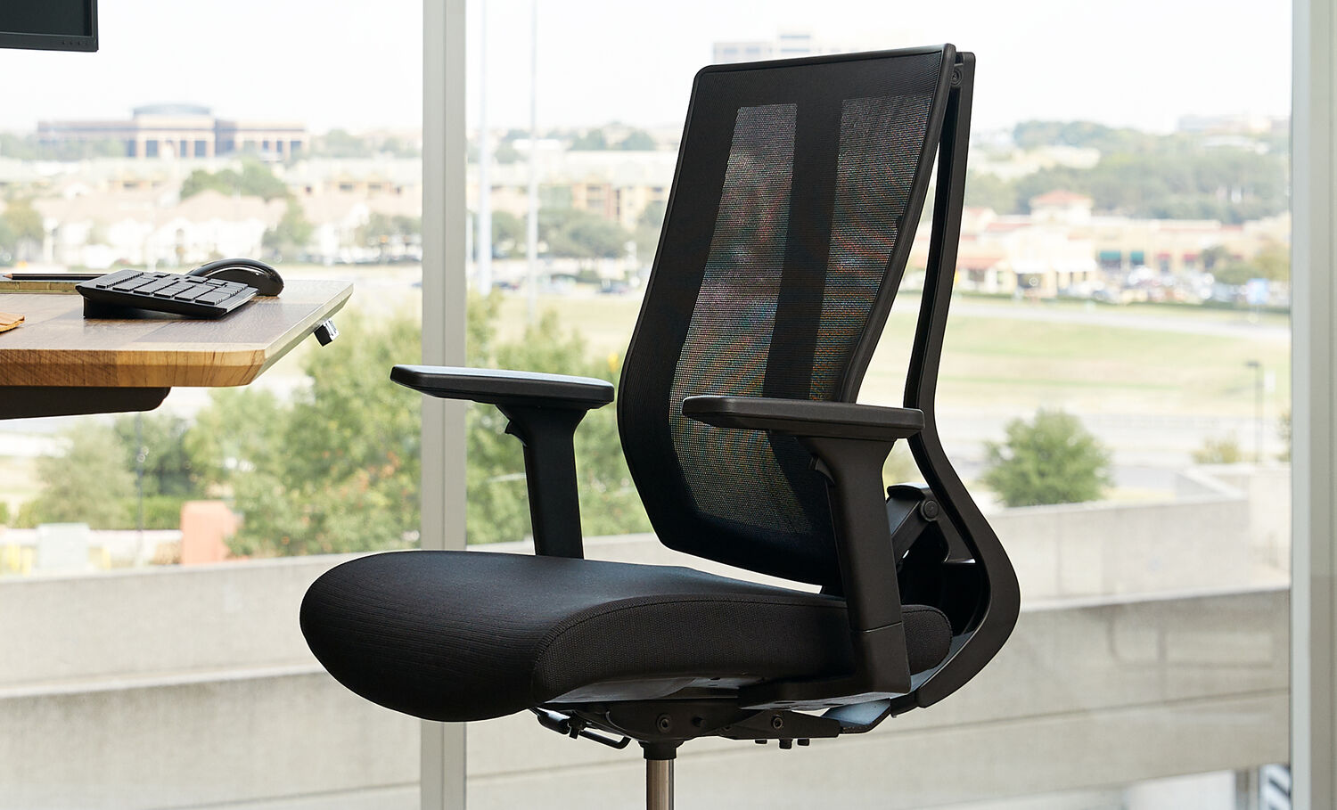 Professional working in office with Vari drafting chair