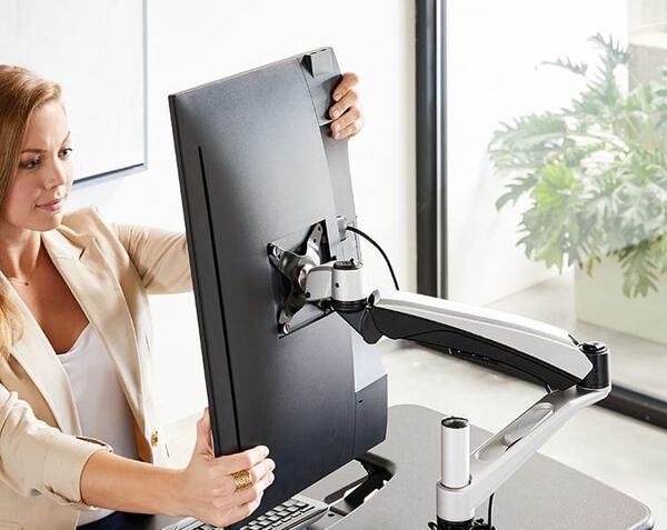professional adjusts monitor to see screen comfortably