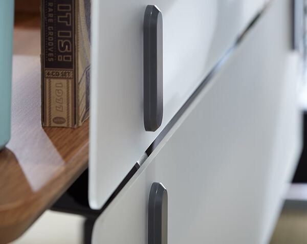close up of two acrylic modesty panels attached to a desk