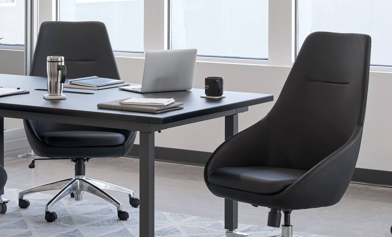 high back conference chair paired with conference table to create an upscale meeting area