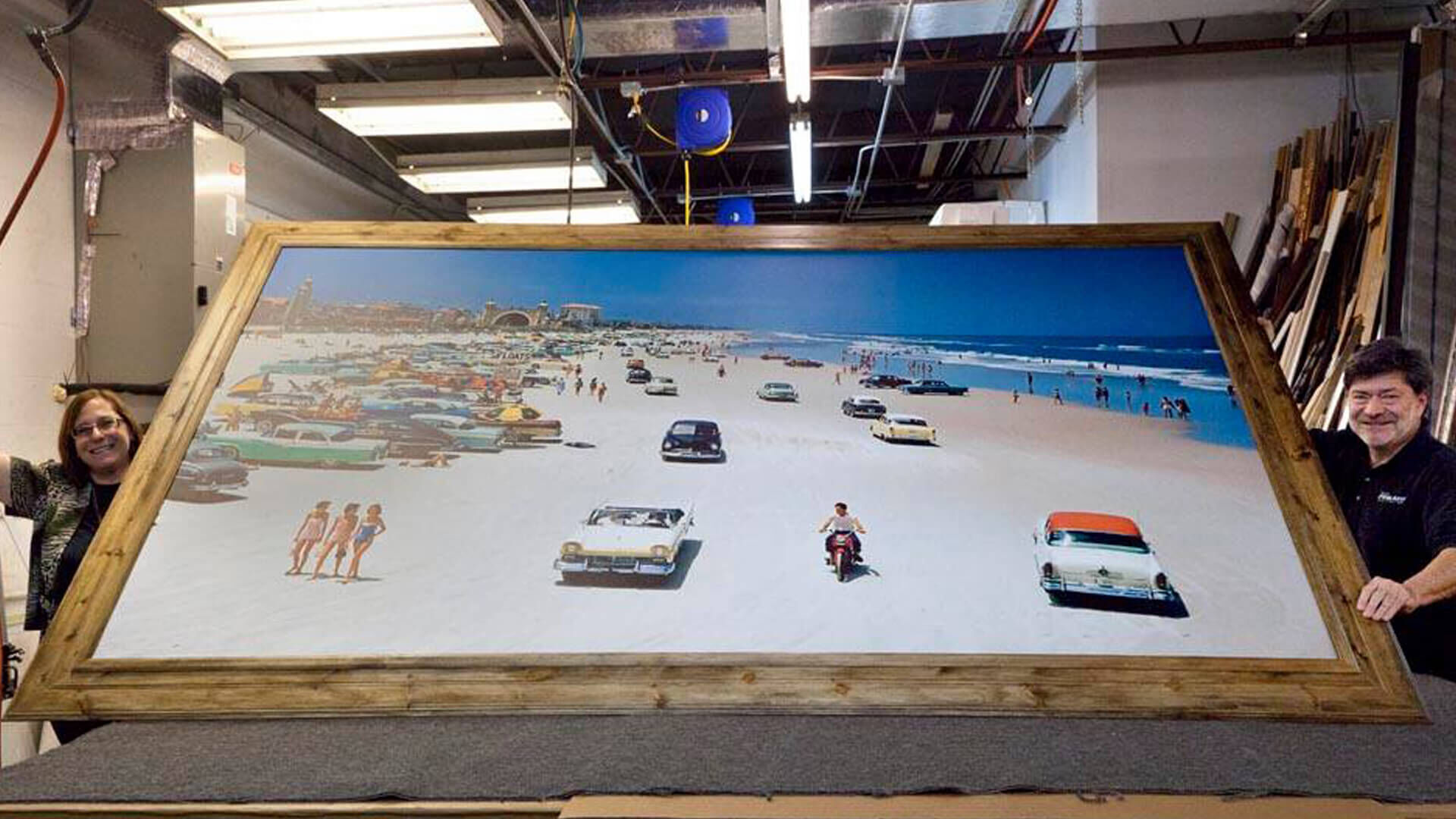 two people propping up large frame