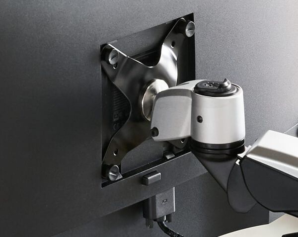 monitor attachment hardware seen from back, with the four hand tightened screws