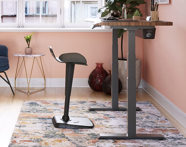side view of an ergo electric standing desk in a home office setting
