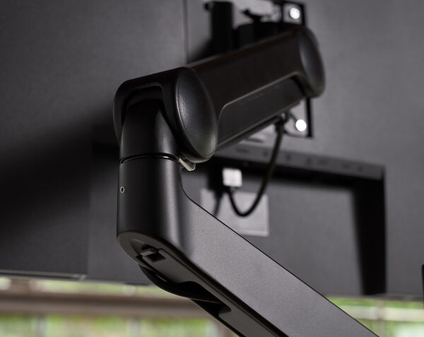 close up of monitor arm attaching to monitor