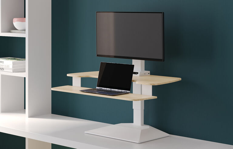 varidesk premier electric converter in light wood on top of a desk with a laptop setup on the attached keyboard tray
