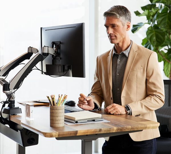 professional working at electric standing desk 