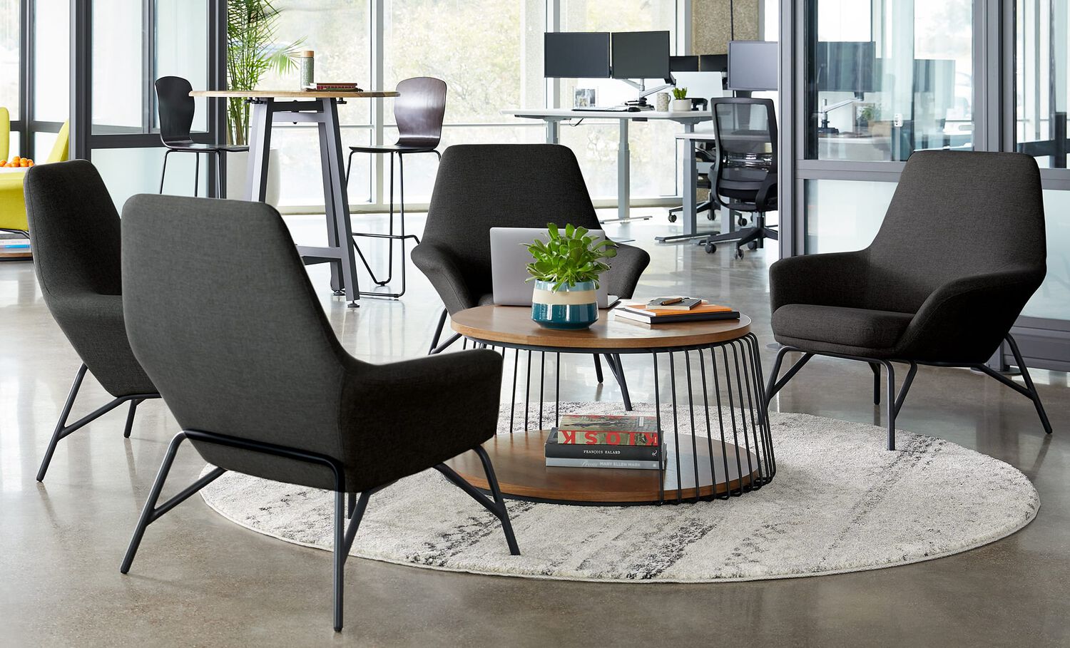 4 arm chairs and a table create a lounge area in an office setting