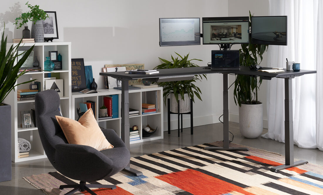 Person working at VariDesk Converter with two monitors