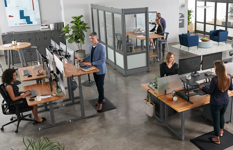 individuals working in office with vari products