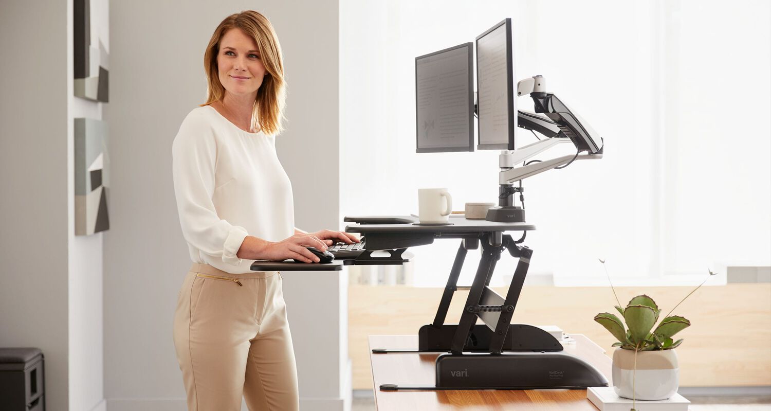 individuals working at their workspaces in an open office