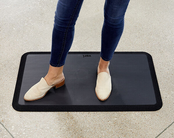 professional stands on mat and exhibits the support offered by it