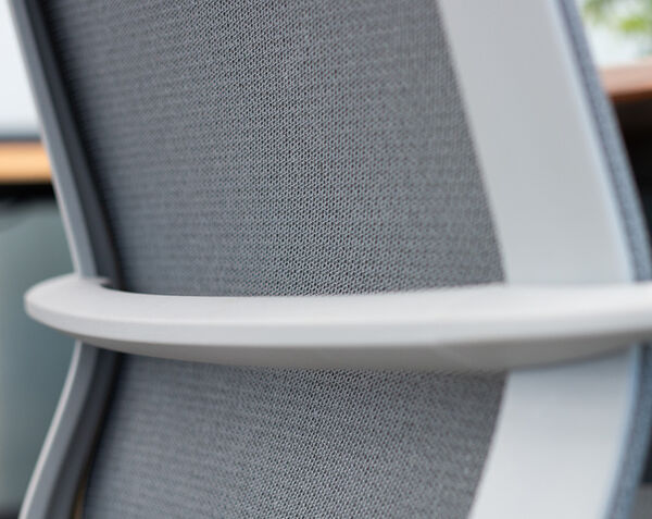 person sitting on ascent chair with closeup of lumbar support