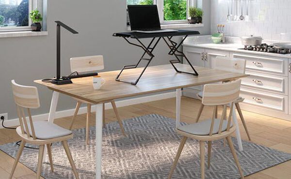 varidesk laptop 30 converter with accessories sits ontop of kitchen table for a home office setup