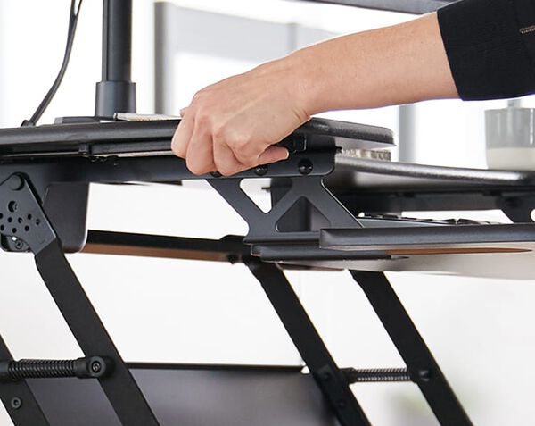 Individual raising desk converter to raised position