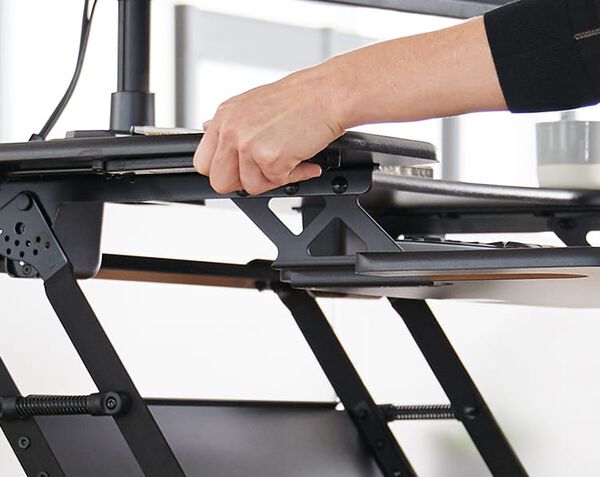 Individual raising desk converter to raised position
