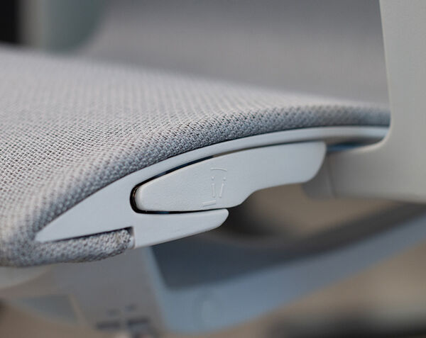 Close-up of Ascent chair lever beneath the seat for reclining or tilt adjustment.