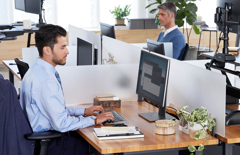 Two individuals working at their desks.