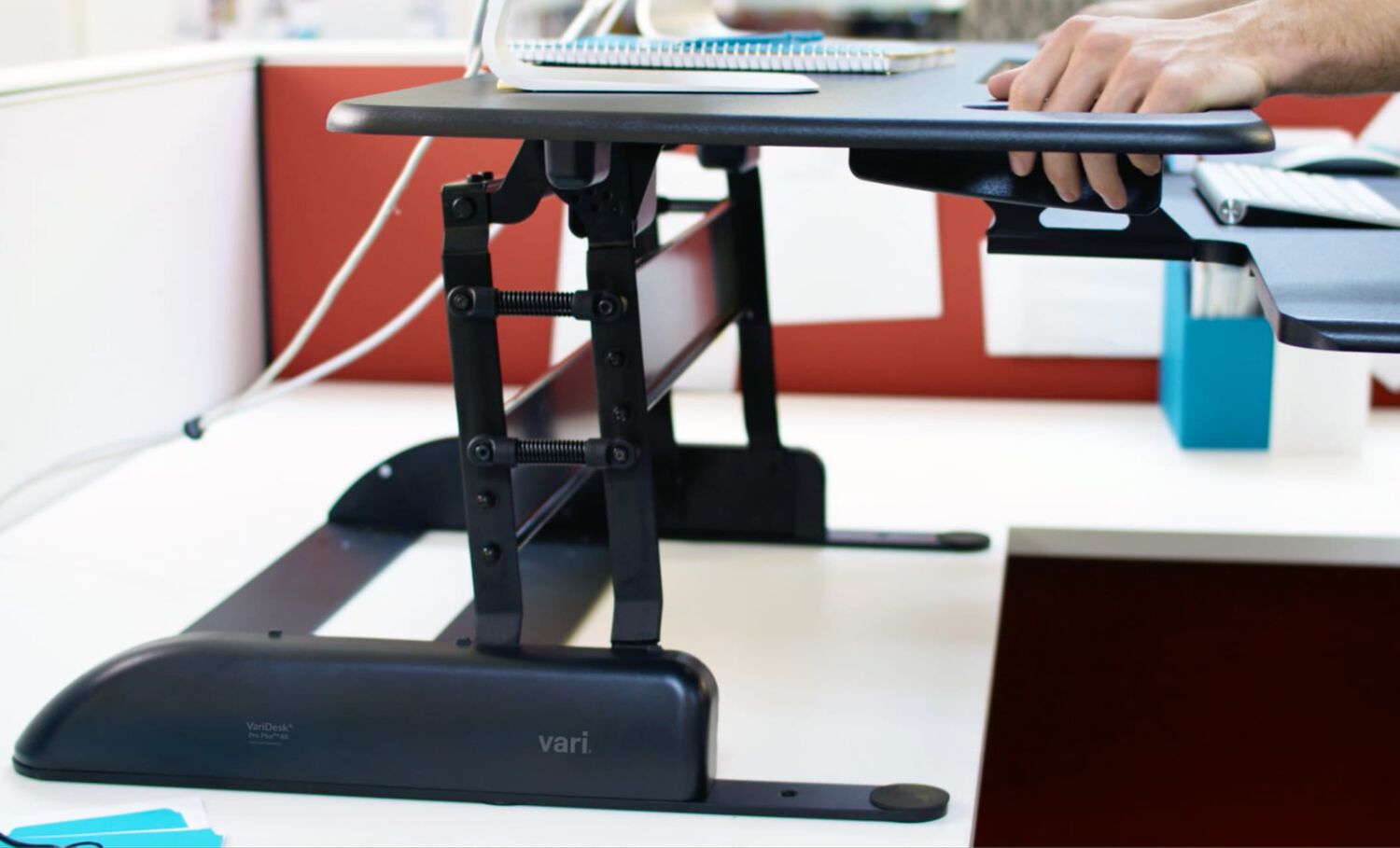 Sideview of desktop riser being raised to maximum height