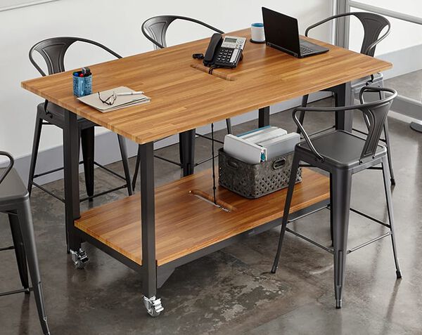 table shown with five chairs and still places to stand.