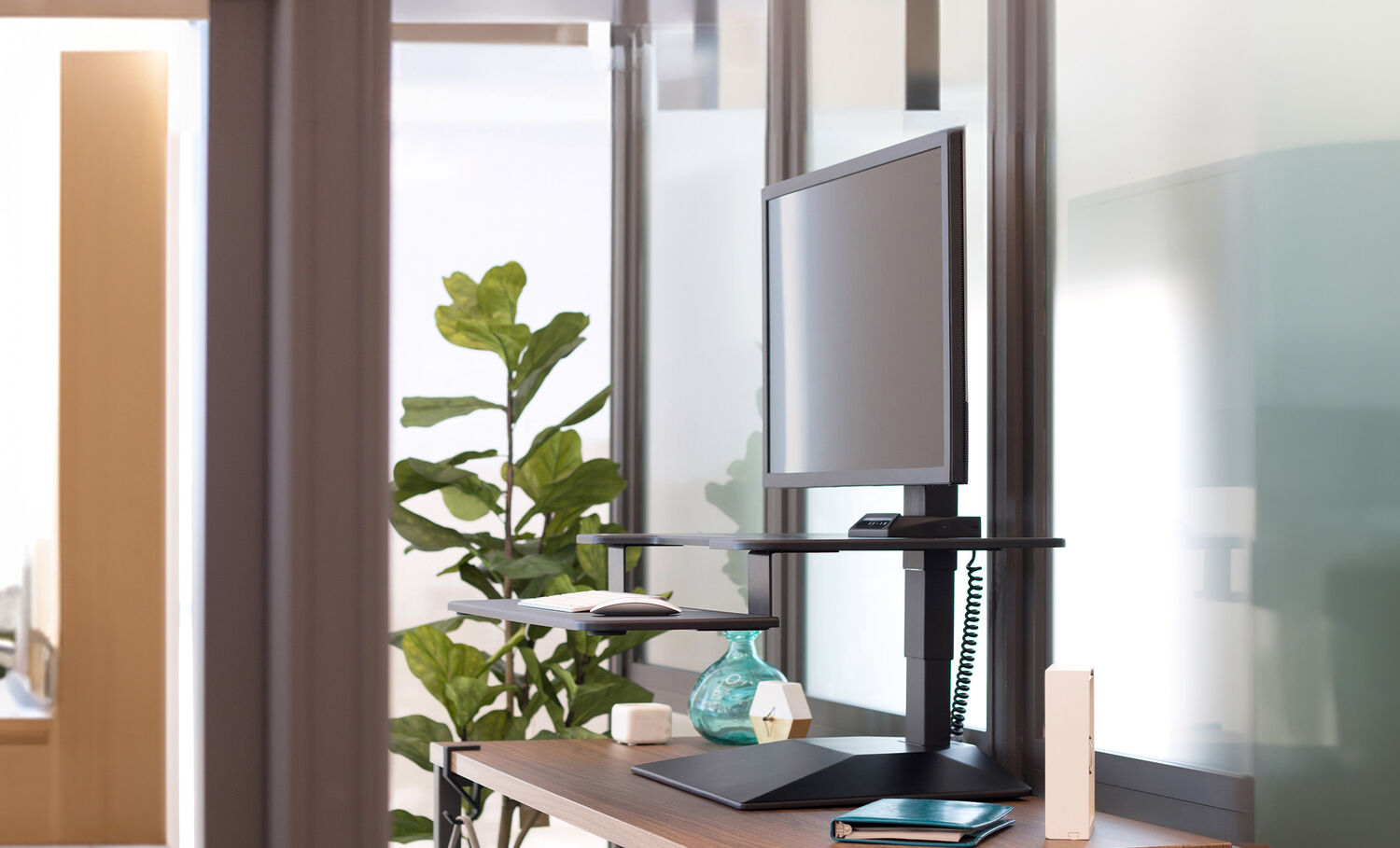 side view of the premier electric single monitor converter showcasing the depth of the product on a fixed height desk in a raised position
