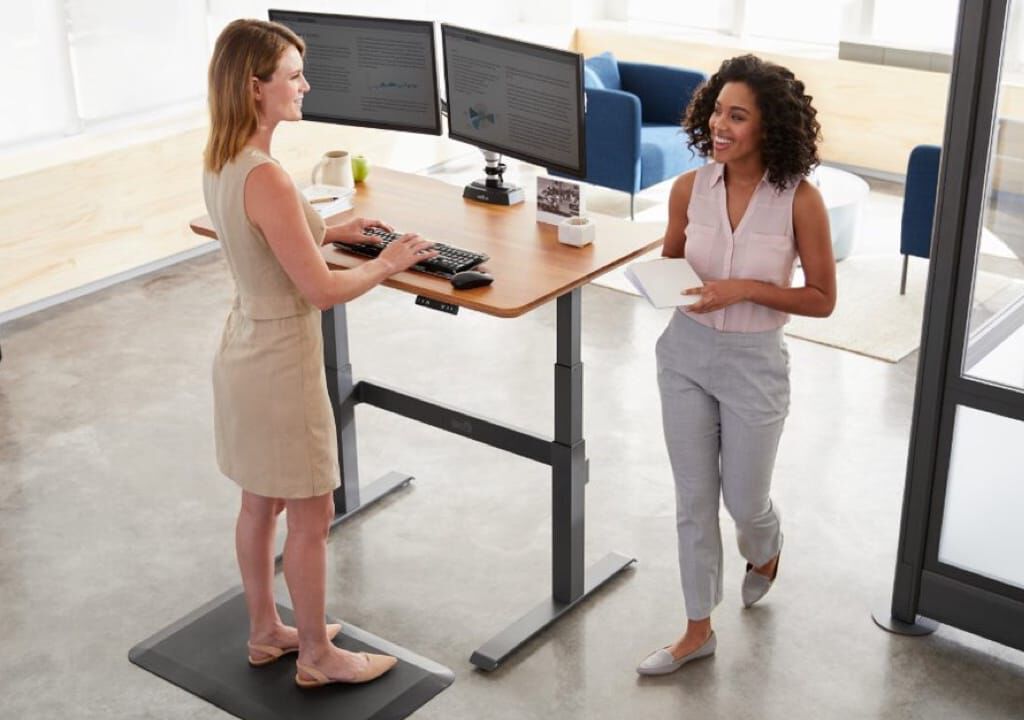 two professionals greet each other while standing