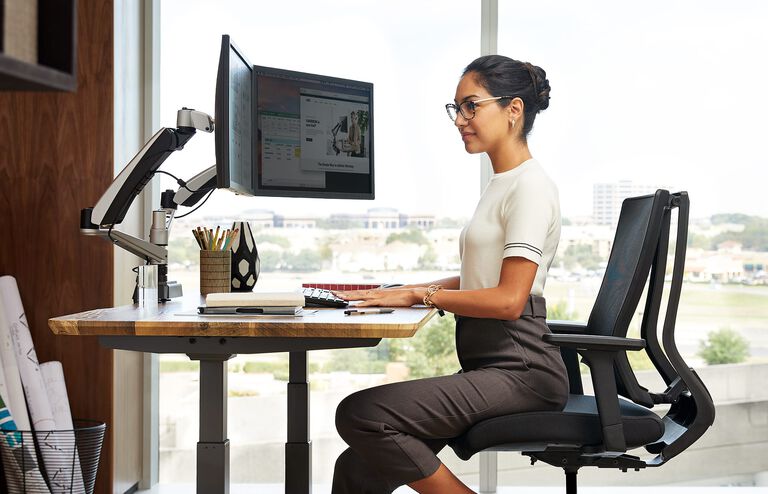 Professional working in office chair with Vari products