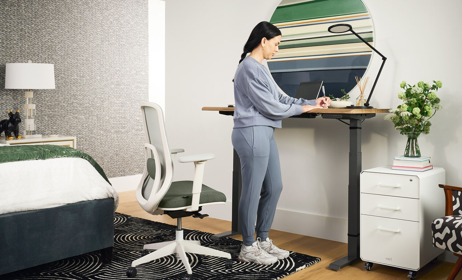 professional standing in home office setting with ascent chair