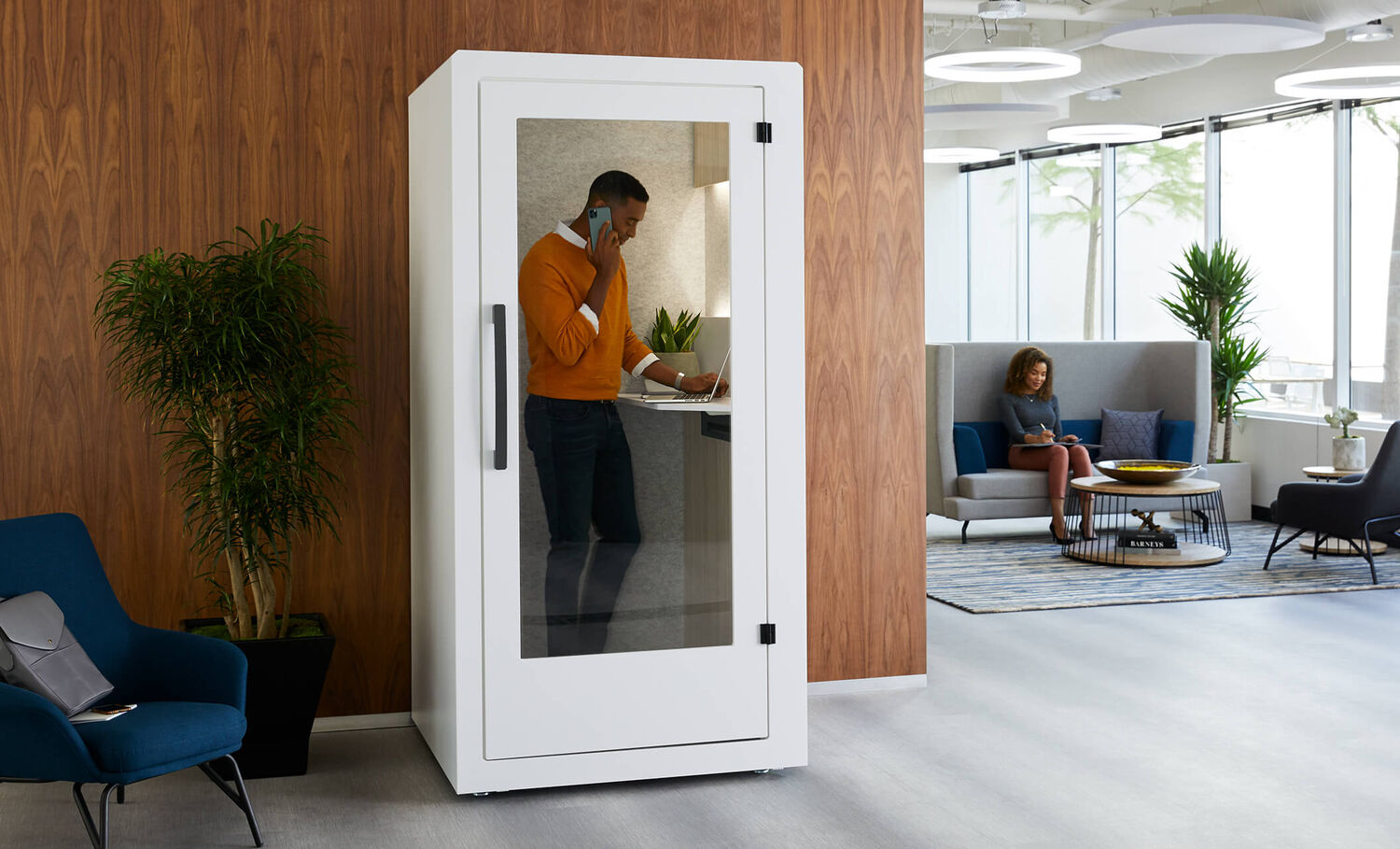 professional talking on the phone inside a privacy booth