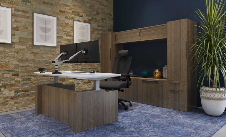 A private office with modular storage cabinets behind a standing desk with a wraparound wooden base.