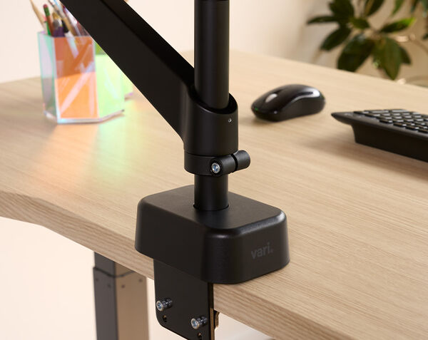 close up view of the base of the dual monitor arm that installs to the edge of the desk