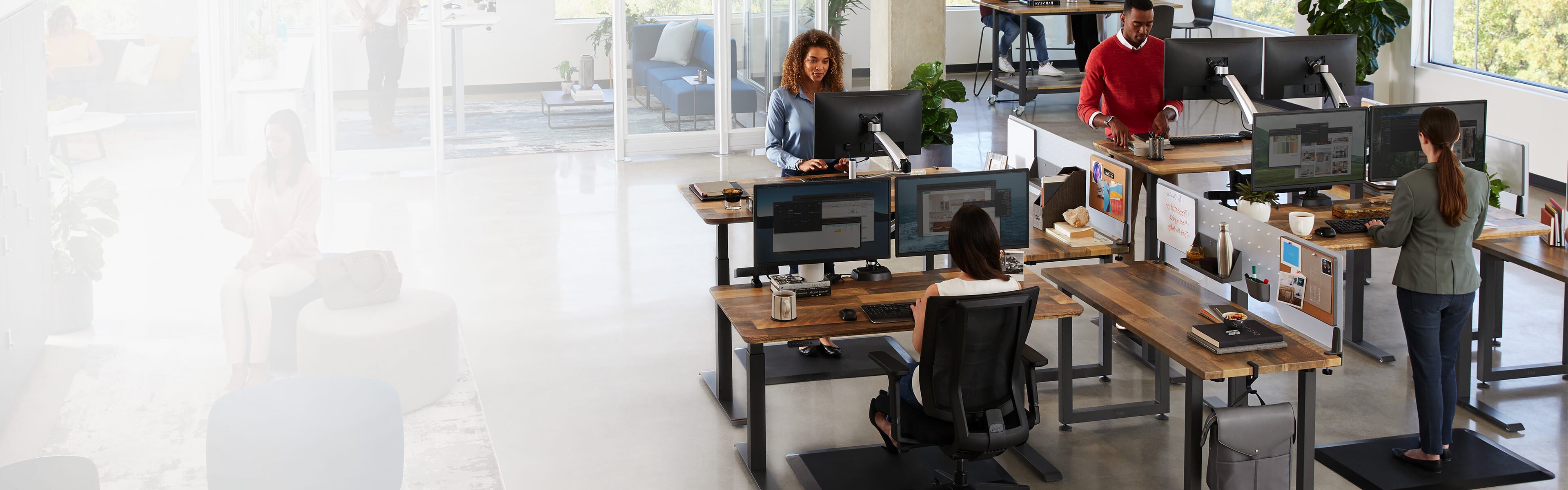 people reviewing a space plan in an office undergoing a furniture design project