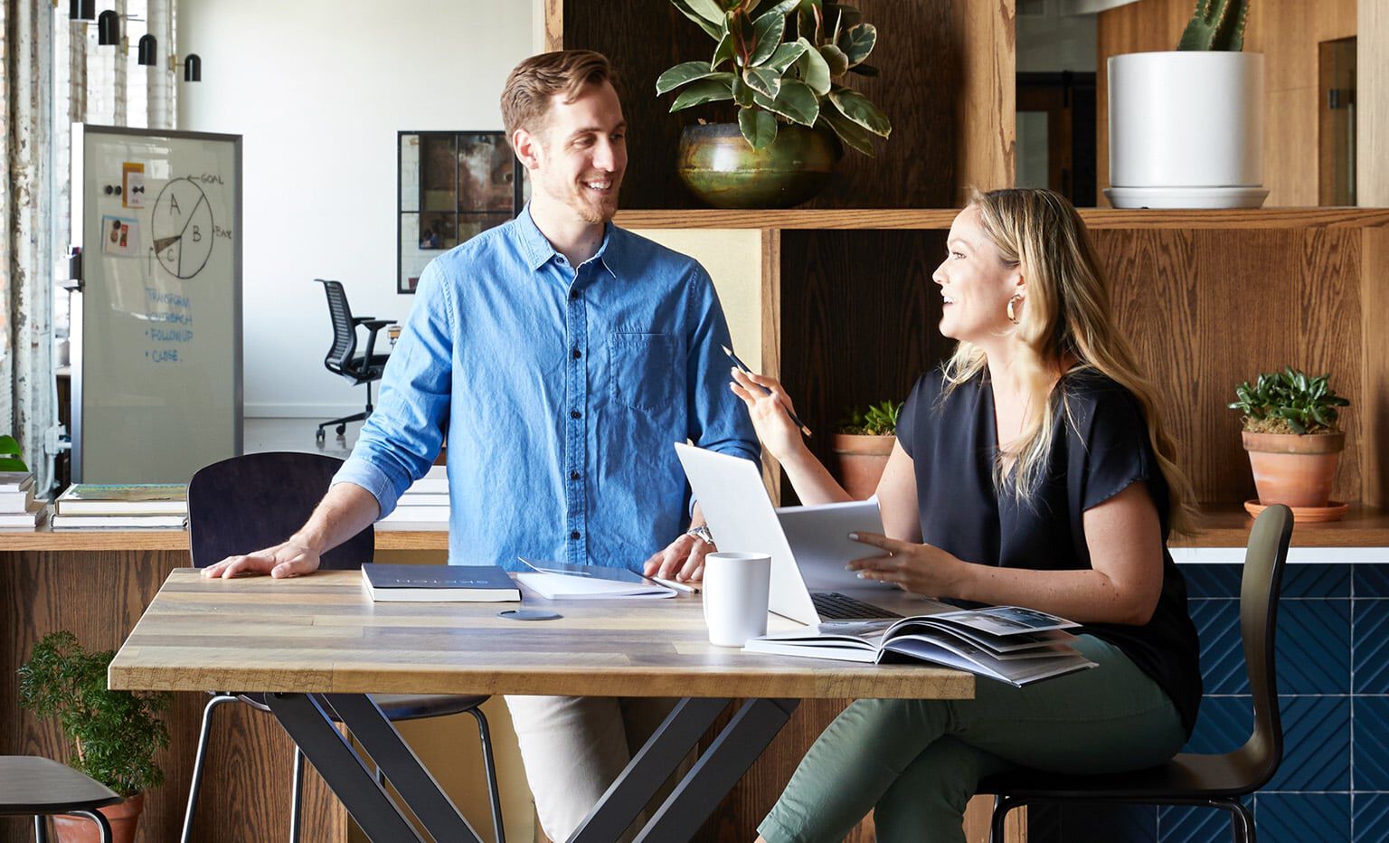 coworkers collaborate at a standing-height meeting table