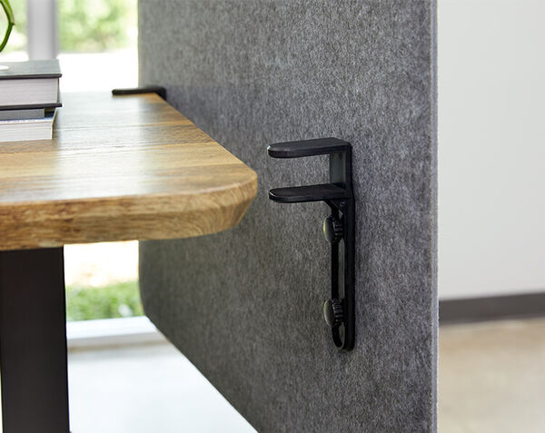 Closeup of felt panel attached to desk with mounting hardware
