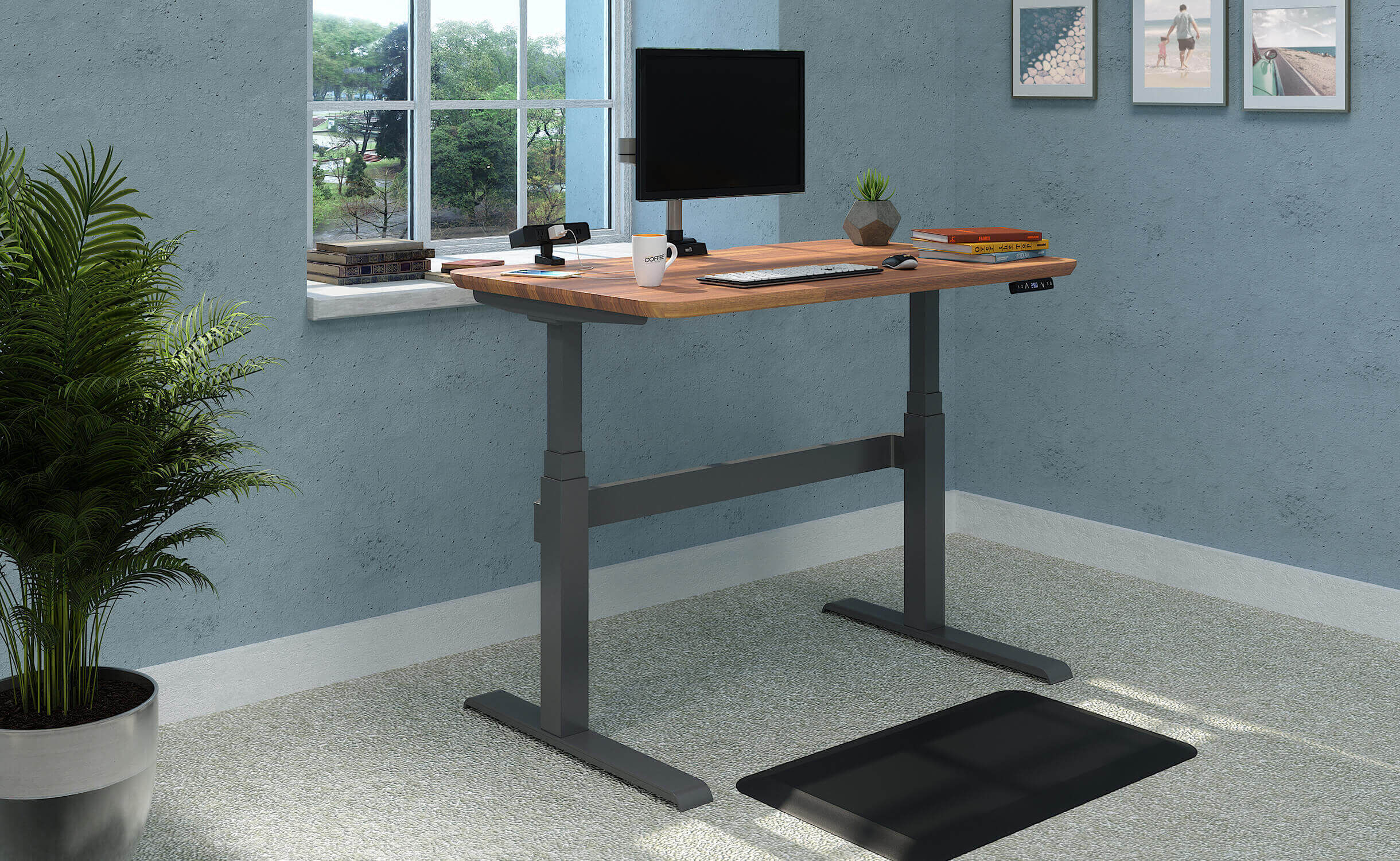 Vari Electric Standing Desk in butcher block with accessories in home office.