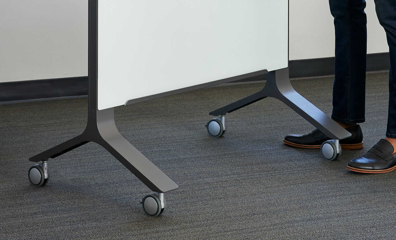 close up view of vari mobile glass board 40 by 72 legs and casters